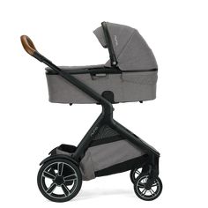 the grey stroller is on display against a white background