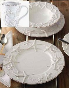 white plates and silverware sitting on a wooden table