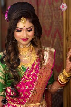 a woman in a green and pink sari