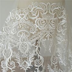 the white lace is hanging on the wall