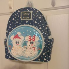 Loungefly Disney Mickey & Minnie Mouse Snow Globe Mini Backpack New With Tags Add A Touch Of Disney To Your Holiday Outfits With This Loungefly Mini Backpack! Featuring A Front Pocket Graphic Of Adorable Snowmen Made To Look Like Mickey And Minnie Mouse, The Mini Poms Make For A Snow Globe-Like Display, Allowing Fans To Bring A Bit Of Snow Day Fun Whenever They Don This Bag. Complete With An Allover Print Design Of Falling Snow (Including Certain Mouse-Eared Snow Particles!), This Style Is The P White Mickey Mouse Backpack For Disney Trips, White Mickey Mouse Backpack For Travel, White Mickey Mouse Travel Backpack, Cute White Mickey Mouse Bags, Loungefly Mini Backpack, Falling Snow, Mickey And Minnie Mouse, Loungefly Disney, Mickey And Minnie