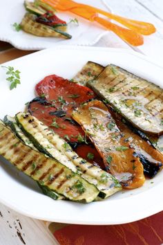 grilled vegetables are served on a white plate