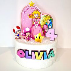 a birthday cake with mario and princess peach on top, surrounded by other characters from the nintendo video game