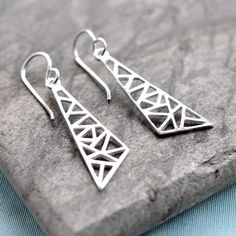 Our sublime Silver Asymmetric Triangle Earrings are sure to become an everyday essential with there stylish sparkle and shine. This Geometric Jewellery Range, is inspired by repetitive patterns is extremely versatile and gorgeous to wear. Perfect for a night out with the girls but smart enough to wear to work the next day.  It is believed that triangles and other three part emblems symbolise concepts such as mind, body and soul or past, present and future. These Sophisticated Silver Asymmetric T Triangle Jewelry, Bubble Earrings, Triangle Necklace, Geometric Triangle, Triangle Earrings, Geometric Jewelry, Everyday Earrings, Stunning Jewellery, Recycled Sterling Silver