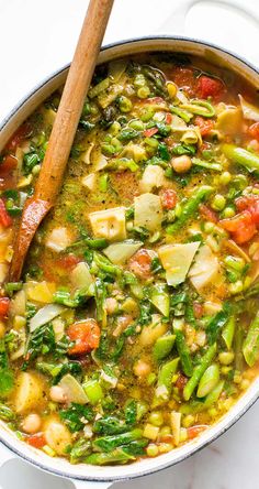 a pot filled with vegetable soup on top of a white counter