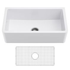 a white kitchen sink with grids on the bottom