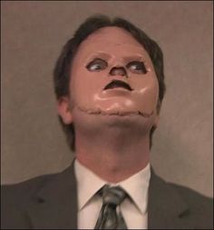 a man in a suit and tie with a fake head on his face looking up