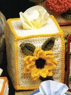 crocheted tissue boxes with flowers on them