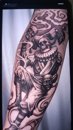 a man's arm with a black and white image of a skeleton riding an elephant