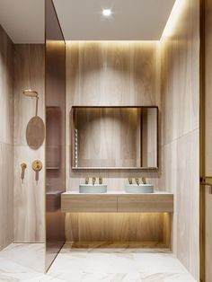 a bathroom with two sinks, mirrors and lights on the wall next to each other