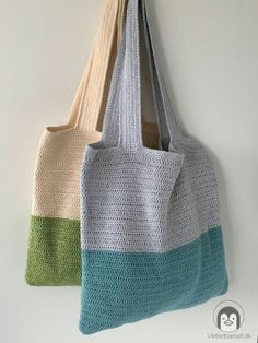 two crocheted totes hanging on the wall, one is multicolored