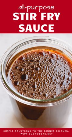 a jar filled with sauce sitting on top of a white counter next to a red sign that says, all purpose stir fry sauce