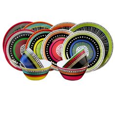 colorful bowls with designs on them are stacked in the shape of an abstract design, and one is empty