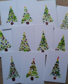 six christmas cards with different colored trees on them, all lined up in the same row