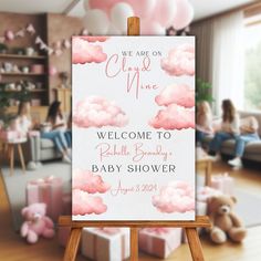 a welcome sign for a baby shower is displayed in front of a room filled with pink balloons