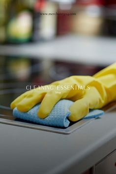 a pair of yellow gloves sitting on top of a stove