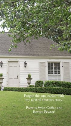 a white house with two planters in front of it and the words forgeter written below