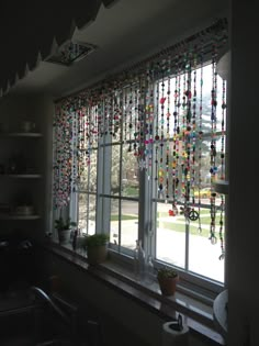 a kitchen window covered in lots of colorful beads