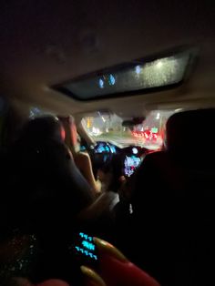 people in the back seat of a car at night