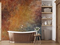 a bath tub sitting in front of a wall with a painting on it's side