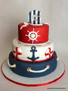 a three tiered cake with an anchor on top