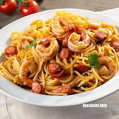 pasta with shrimp and tomatoes in a white bowl