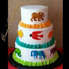 there is a three tiered cake with animals on it