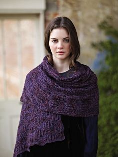 a woman wearing a purple knitted shawl