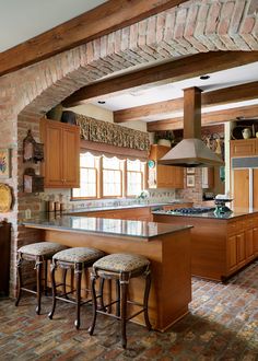 a kitchen with brick walls and wooden cabinets