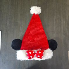 a mickey mouse hat with red and white polka dots on the front, and a bow at the bottom