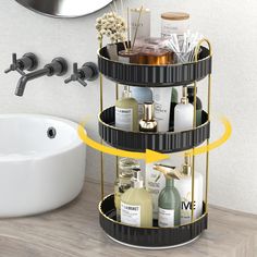 three tiered black and gold bathroom caddy with soaps, shampoos, lotions, and other items