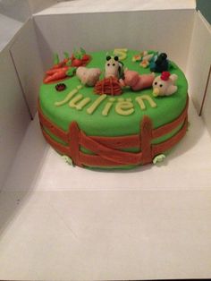 a green cake with farm animals on it