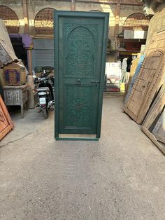 a green door sitting in the middle of a room