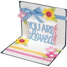 a card that says you are loved with flowers