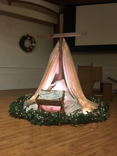 a small bed is set up in the middle of a room with lights on it