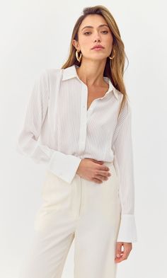 This sleek blouse features a striped print and slightly sheer, satin material. The button down can be styled casually for an eleavted look or worn to work. Shirt Button Down Striped Length: 24 1/2" Chest: 18 1/4" Self: 100% Polyester Hand wash in cold water. Lay flat to dry. Low iron. Model is wearing a size small Style #: G248T7051 Tops And Blouses, Sweater Jumpsuit, Luxury Women Fashion, Work Shirt, Satin Material, Low Iron, Shirt Button, Modern Woman, Fashion Games