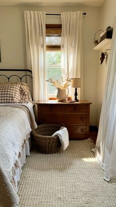 a bed room with a neatly made bed and a basket