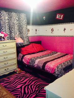 a zebra print bedroom with pink and black decor