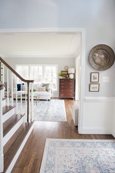 a living room with white walls and wooden floors