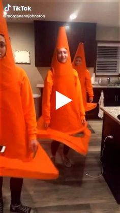 some people in orange costumes are standing together