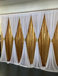 a gold and white backdrop with drapes