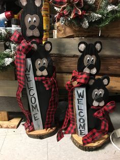 two black and red bear decorations on wooden logs