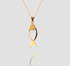 Discover the elegance of simplicity with our exclusive Fish Necklace, a stunning piece of jewelry that effortlessly blends style and sophistication. fish size: around 12mm-13mm *  around 7mm-8 mm  chain length: about  42 centimeters Material: 14k solid gold and also 10k and 18k gold Style: Minimalism this handmade pendant showcases a minimalistic fish design, perfect for adding a touch of class to any outfit. Ideal as a heartfelt gift, this necklace is a timeless treasure for Christmas, Valentine's Day, or any special occasion. Its delicate yet durable construction ensures it can be cherished for years to come. Whether you're shopping for a loved one or treating yourself, this Fish Necklace is more than just an accessory; it's a symbol of love and elegance. Experience the perfect blend of Elegant 14k Gold Fish-shaped Jewelry, Elegant Fish-shaped Formal Jewelry, Elegant Yellow Gold Fish Shaped Necklace, Handmade Pearl Necklace, Fish Pendant Necklace, Minimal Christmas, Fish Necklace, Fish Pendant, Minimal Necklace