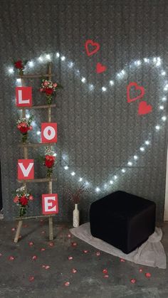 a room decorated for valentine's day with lights and decorations on the wall,