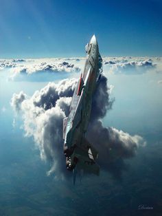 a fighter jet flying through the sky above clouds