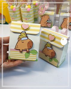 a person holding up some small cards with animals on them