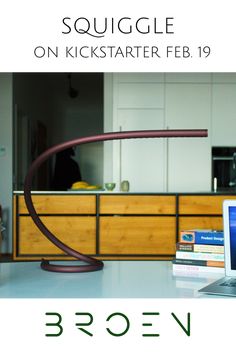 an open laptop computer sitting on top of a white counter next to a wooden dresser