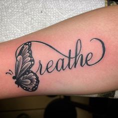 a tattoo with the word breathe written in cursive writing and a butterfly on it