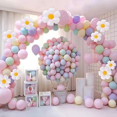 a bunch of balloons that are in the air and some flowers on top of them