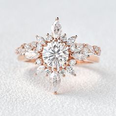 an engagement ring with two pear shaped diamonds on the center and side stones in the middle